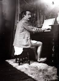 Gaugiom playing the harmonium in Alphonse Mucha’s studio. 1895. Paris.