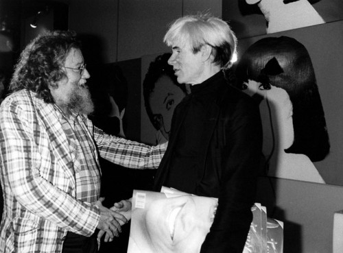 Pierre Restany shaking hands with Andy Warhol