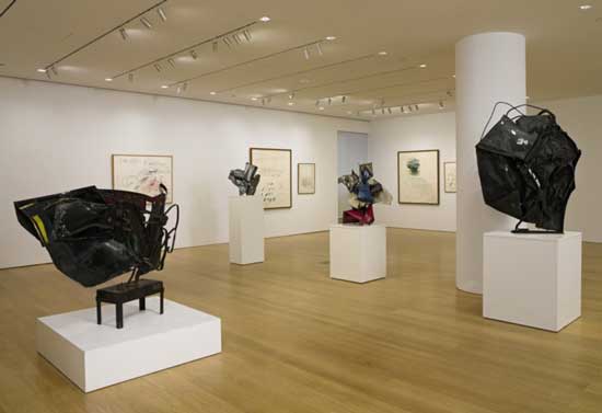 Sotheby's installation shot of Dia's Chamberlains (on pedestals) and Twomblys (on walls) to be auctioned in November