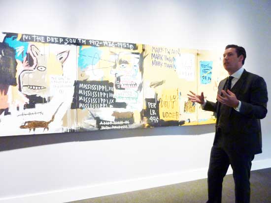 Alex Rotter, Sotheby's Co-Head of Worldwide Contemporary Art. in front of Basquiat, "Undiscovered Genius of the Mississippi," 1983 Photo by Lee Rosenbaum