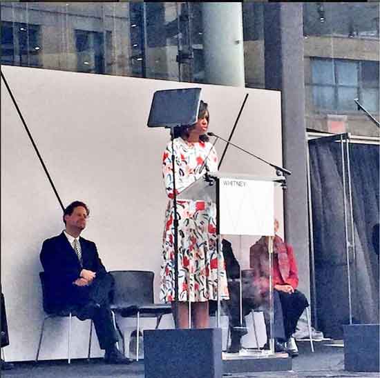 Michelle Obama addresses attendees at Whitney's ribbon-cutting, while director Adam Weinberg looks on Photo from the Whitney's Instagram page