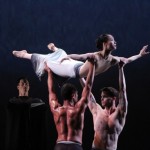 Martha Graham's Rite of Spring. Abdiel Jacobsen (L) and Lloyd Mayor lift Xiaochuan Xie as the Chosen One. The Shaman (Ben Schultz) watches. Photo: Charles Eilber, courtesy of the Martha Graham Dance Company.