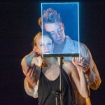 Kristin Clotfelter and Luke Miller behind glass. Photo: Stephanie Berger