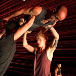 Jeff Sykes (L) and Bryan Strimpel lift Matthew Albert in Brian Brooks's Run Don't Run. Photo: Julieta Cervantes