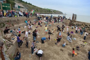 Folkstone Triennial opens. Opening day featured a hunt for 30 pieces of gold buried on the beach by artist Michael Sailstorfer.