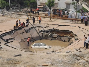 Car in Sinkhole.  Photography used by Fasnacht.