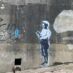 In 2014 A Town Painted Over A Banksy. This Time It Placed Guards To Protect A New One