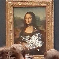 This Guy Dressed Up As An Old Lady, Rolled His Wheelchair Into The Louvre, And Threw A Cake At The Mona Lisa