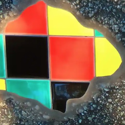 France’s Anonymous Street Artist Fills The Cracks With Colorful Mosaics