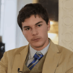 Turns Out The Louvre Photo’s ‘Fedora Man’ Is A 15-Year-Old French Teen Who Loves To Dress Rather Nattily