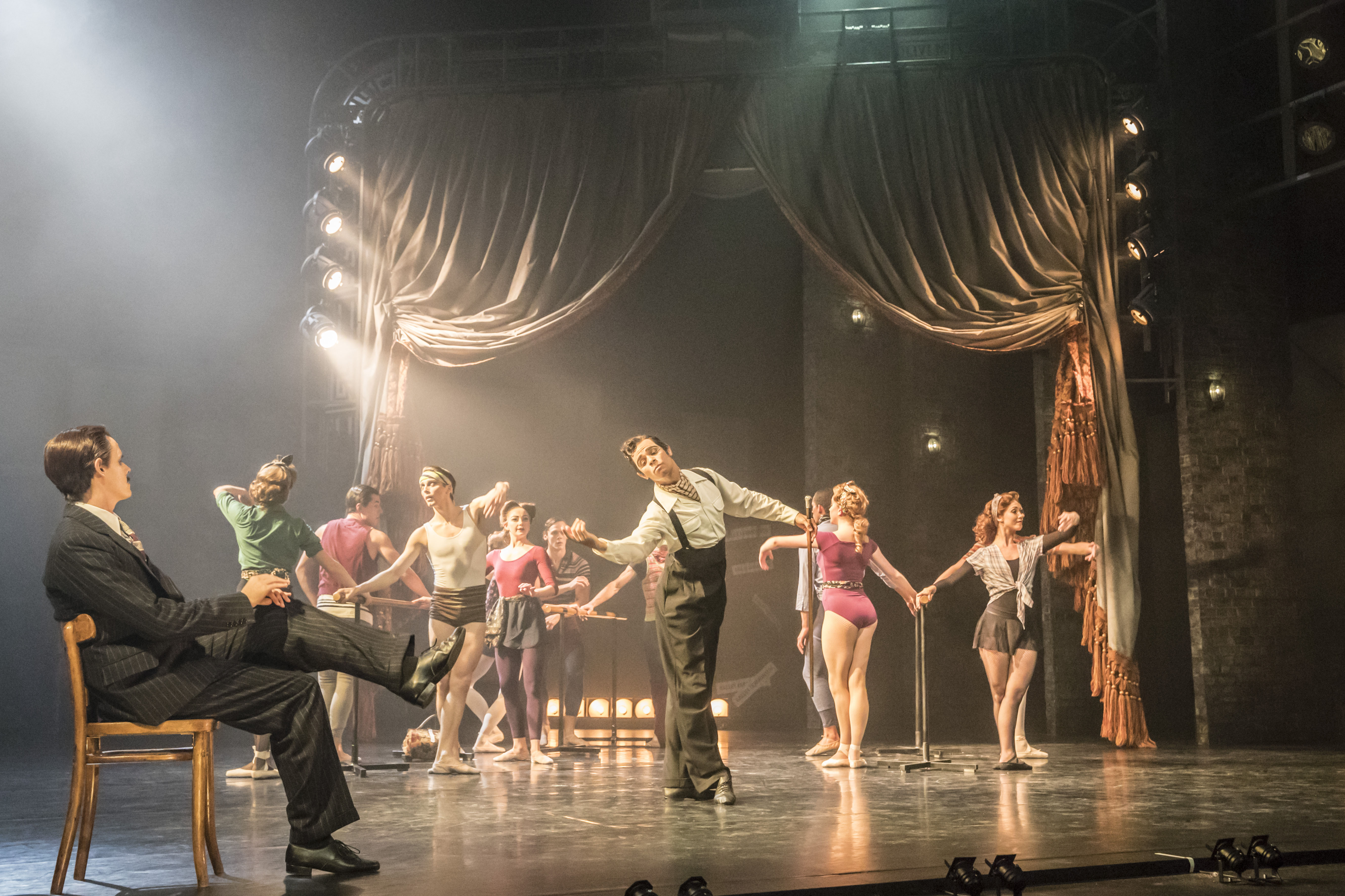 Sam Archer (left, as director Lermontov) and the cast of The Red Shoes. Photo by Johan Persson.