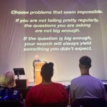 Choose problems that seem impossible. If you are not failing pretty regularly, the questions you are asking are not big enough. If the question is big enough, your search will always yield something you didn't expect.