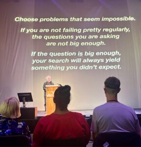 Choose problems that seem impossible. If you are not failing pretty regularly, the questions you are asking are not big enough. If the question is big enough, your search will always yield something you didn't expect.